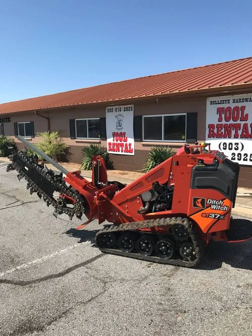 Mini skid steer with trencher attachment